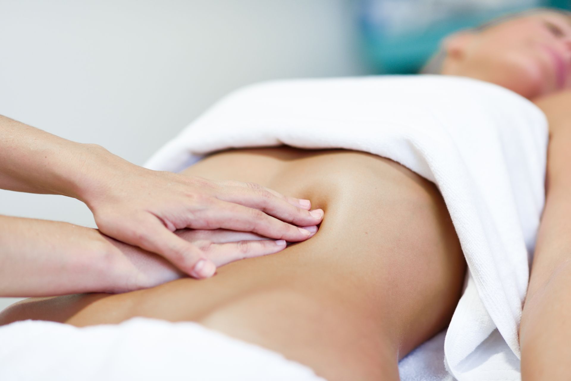 A woman is getting a massage on her stomach