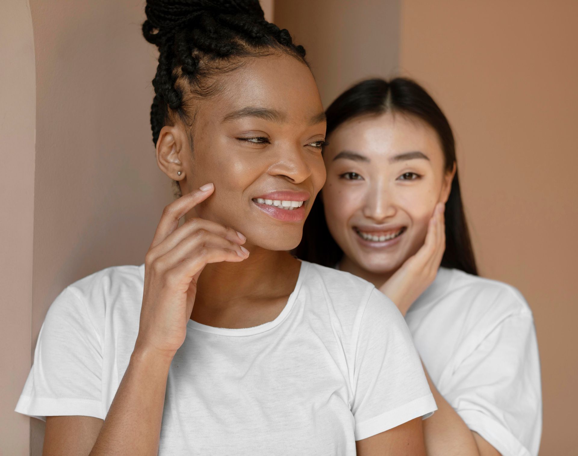 Two women are standing next to each other and smiling.