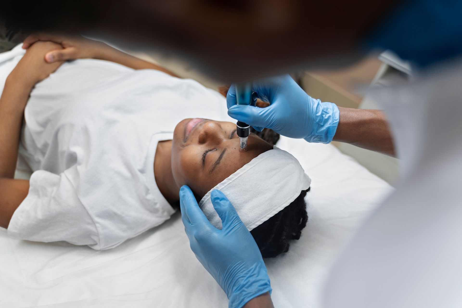 A woman is getting a facial treatment at a beauty salon.