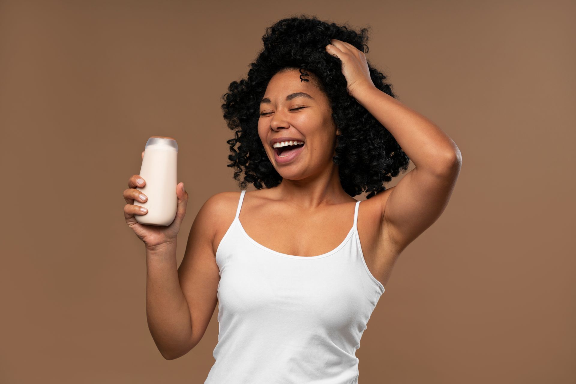 A woman is holding a can of milk and smiling.