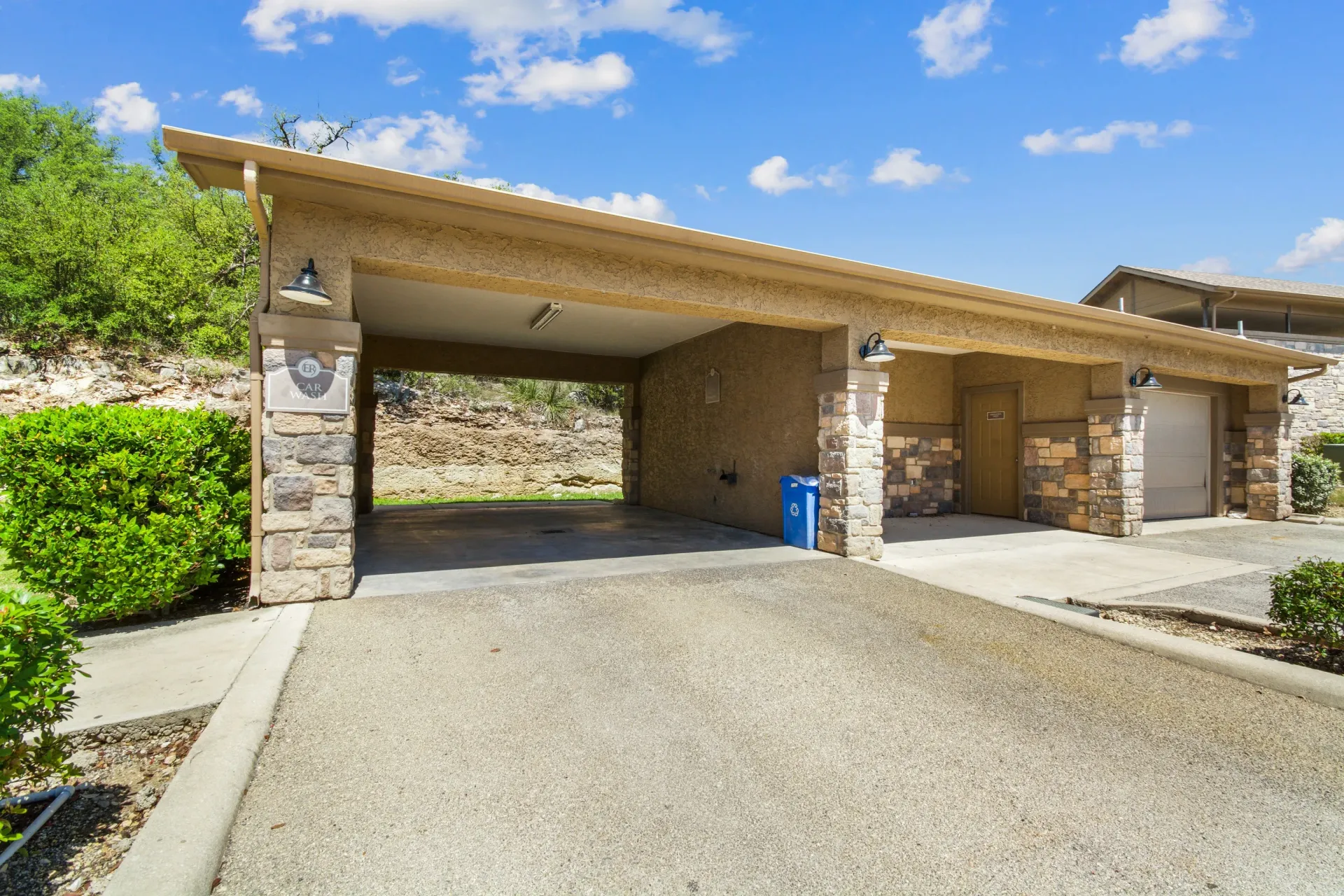 Conference room with a rectangular table and six black chairs, dark blue accent wall, neutral carpet.