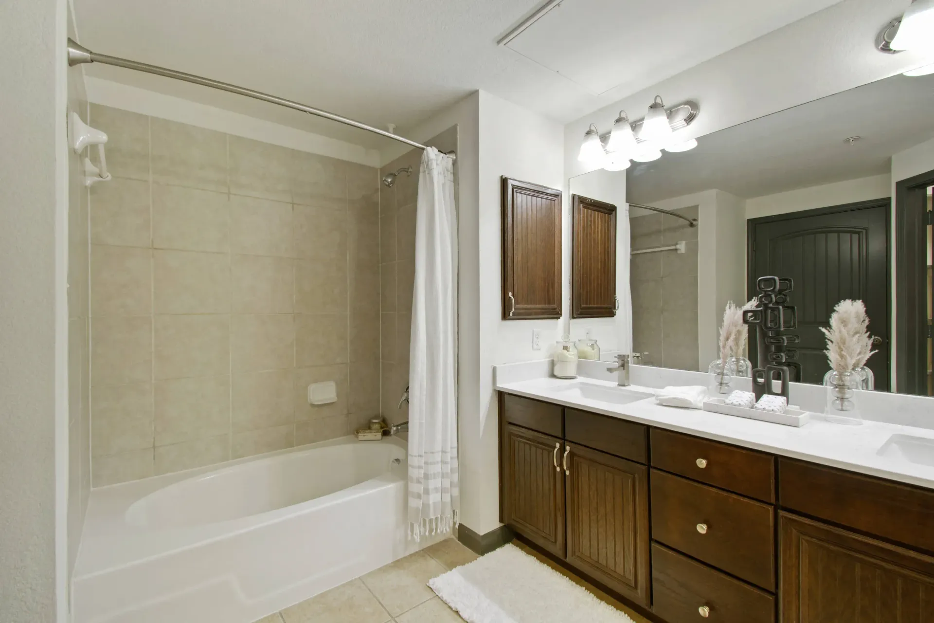 Bedroom with bed, nightstands, artwork, and closet. Window with a view on the right.