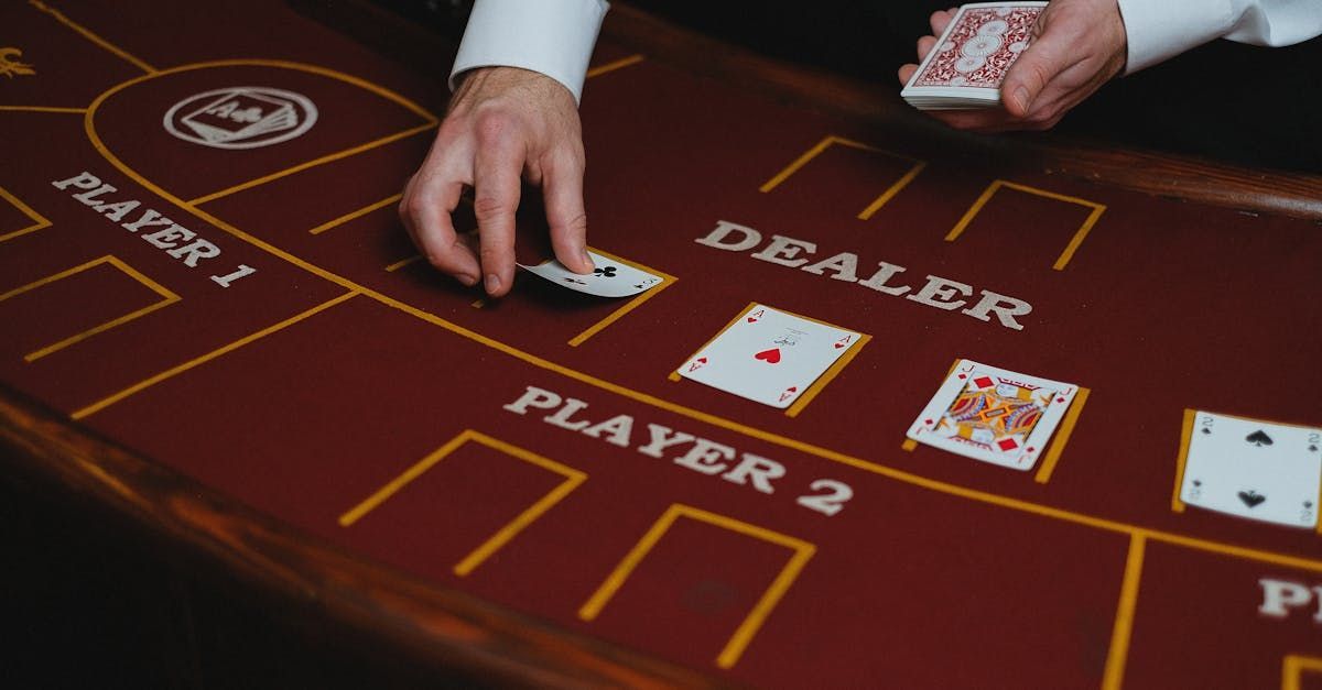 A group of people are sitting around a roulette table in a casino.