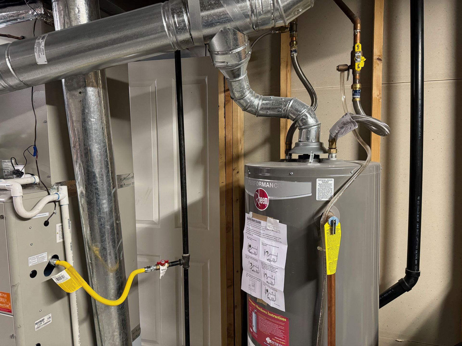A man is working on a rooftop air conditioner.