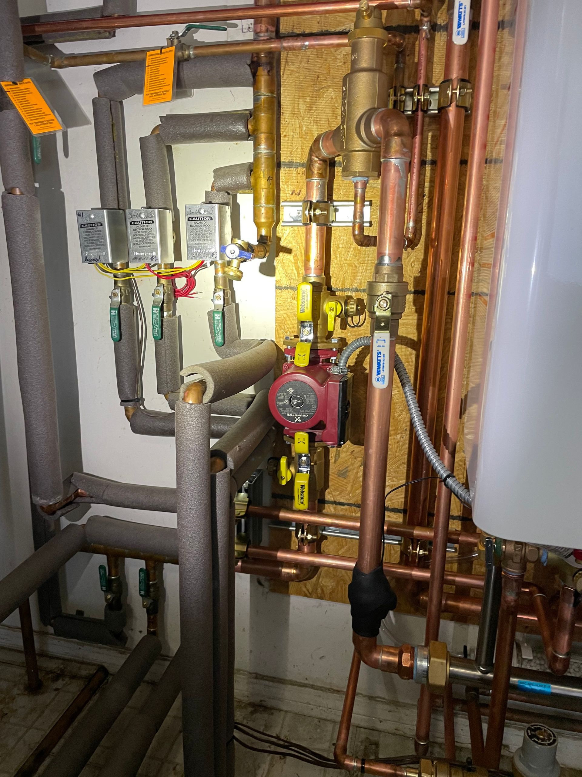 A room filled with lots of copper pipes and valves
