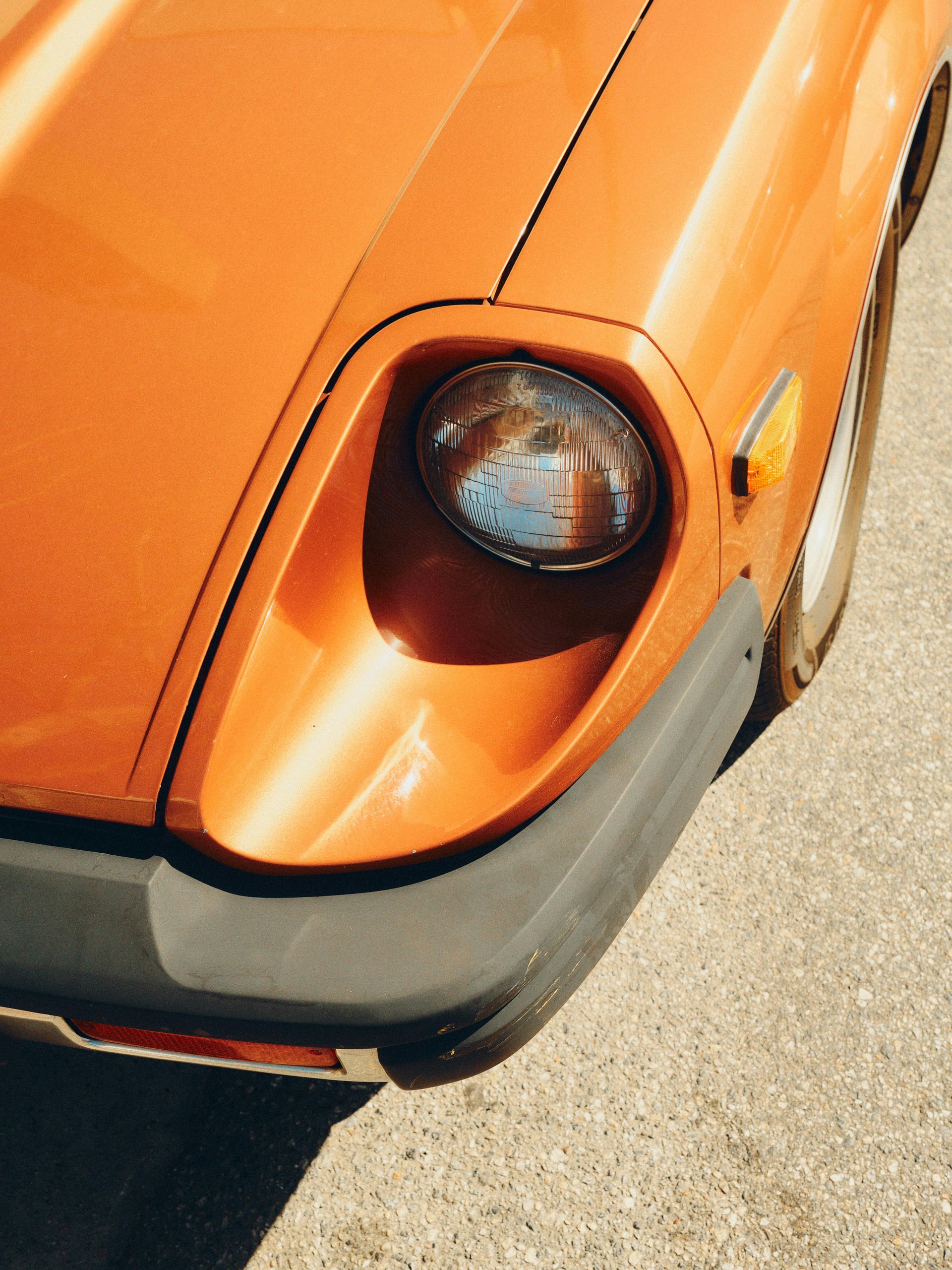 A Extreme close up on orange coloured cars headlight — Central West Paint Supplies in Dubbo, NSW