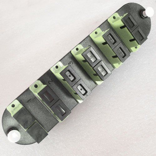 A row of green and black switches on a white surface