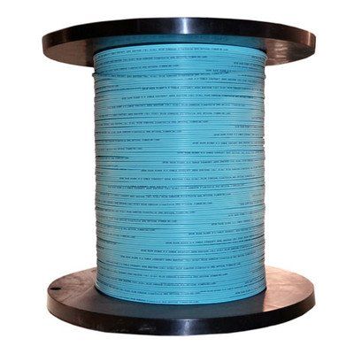 A spool of wire is sitting on top of a wooden spool.