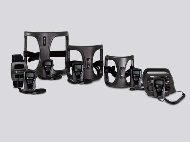 Assorted black pet harnesses and carriers arranged on a light gray background