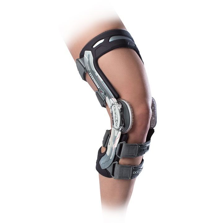 Knee brace with metal hinges and straps on a bent leg