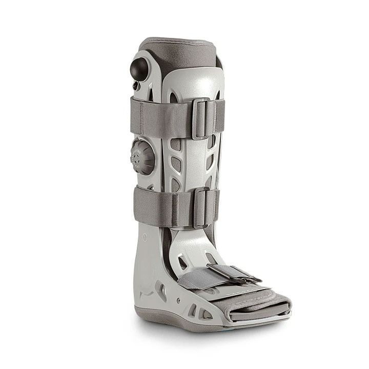 Gray medical leg brace with straps and adjustable supports, isolated on a white background