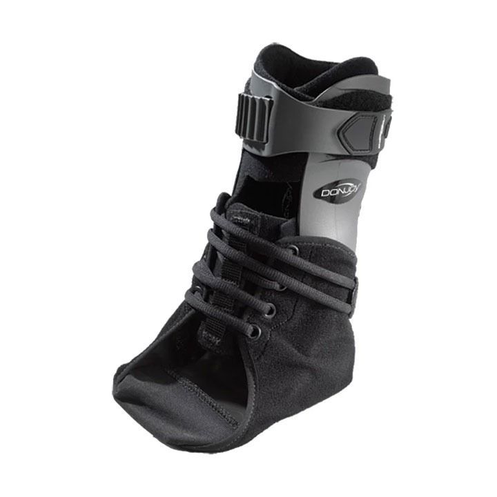 Black orthopedic ankle brace with laces and a strap support on a white background