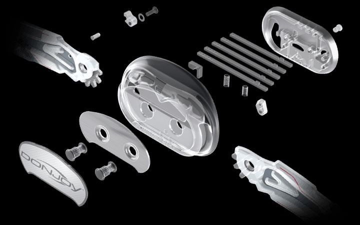 Exploded view of a silver bicycle chain tensioner or derailleur assembly with parts arranged on black background