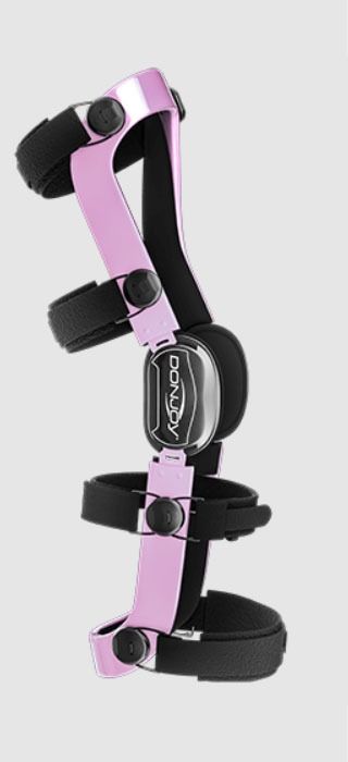 Black and pink orthopedic leg brace with adjustable straps and metal hinges