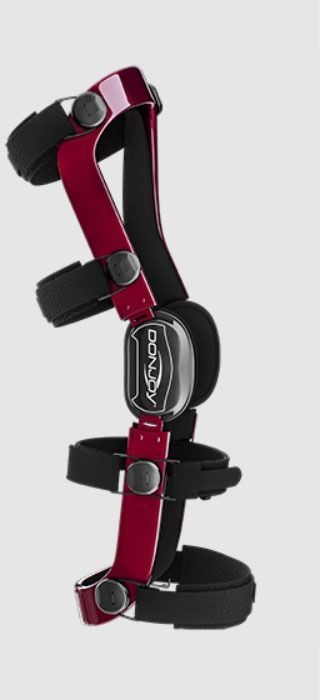 Black and burgundy orthopedic knee brace with adjustable straps on a white background