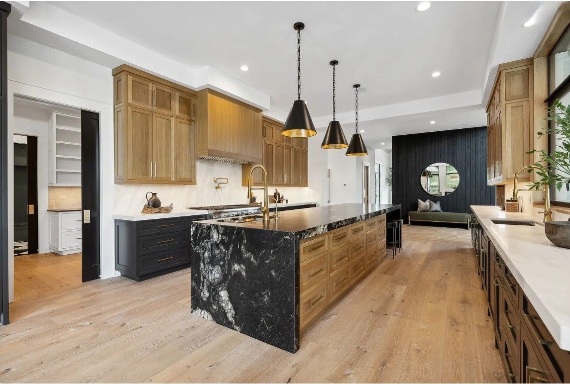 A kitchen with a light hanging from the ceiling.