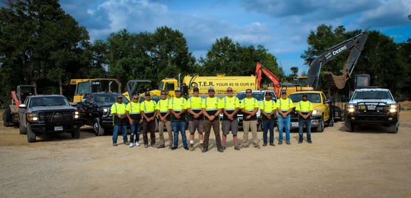 A promotional image featuring the T.E.R. Septic team with their vehicles and equipment, overlaid with the company's logo and branding, highlighting their services.