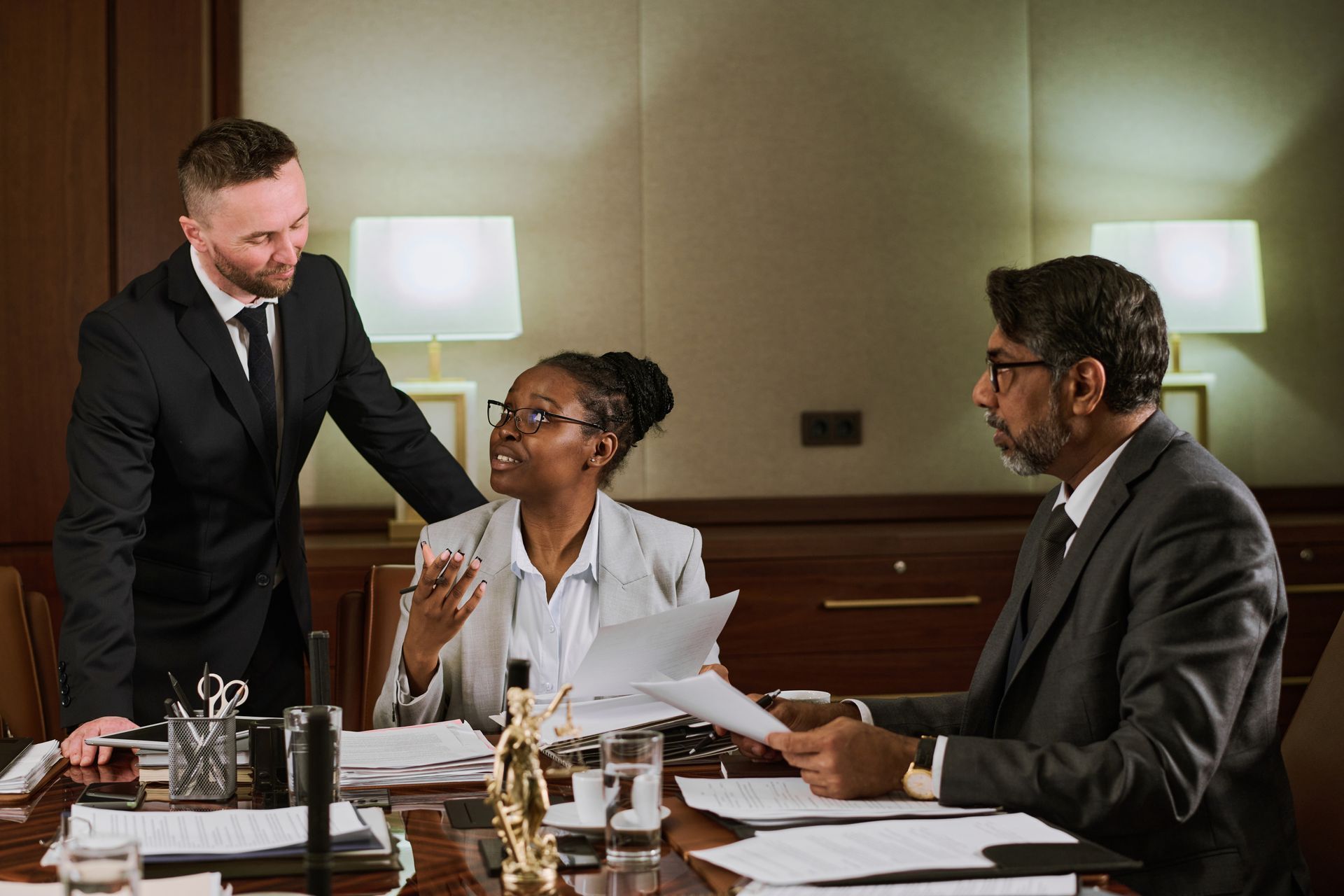 A group of business people are sitting at a table having a meeting.