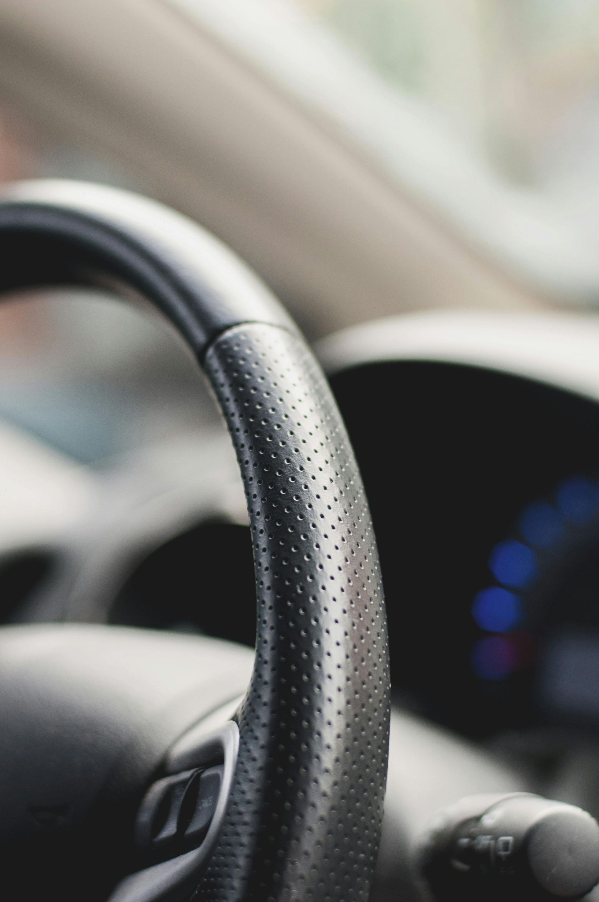 A close up of a steering wheel in a car