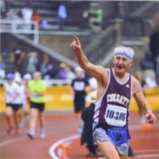 A man wearing a colgate jersey is running on a track