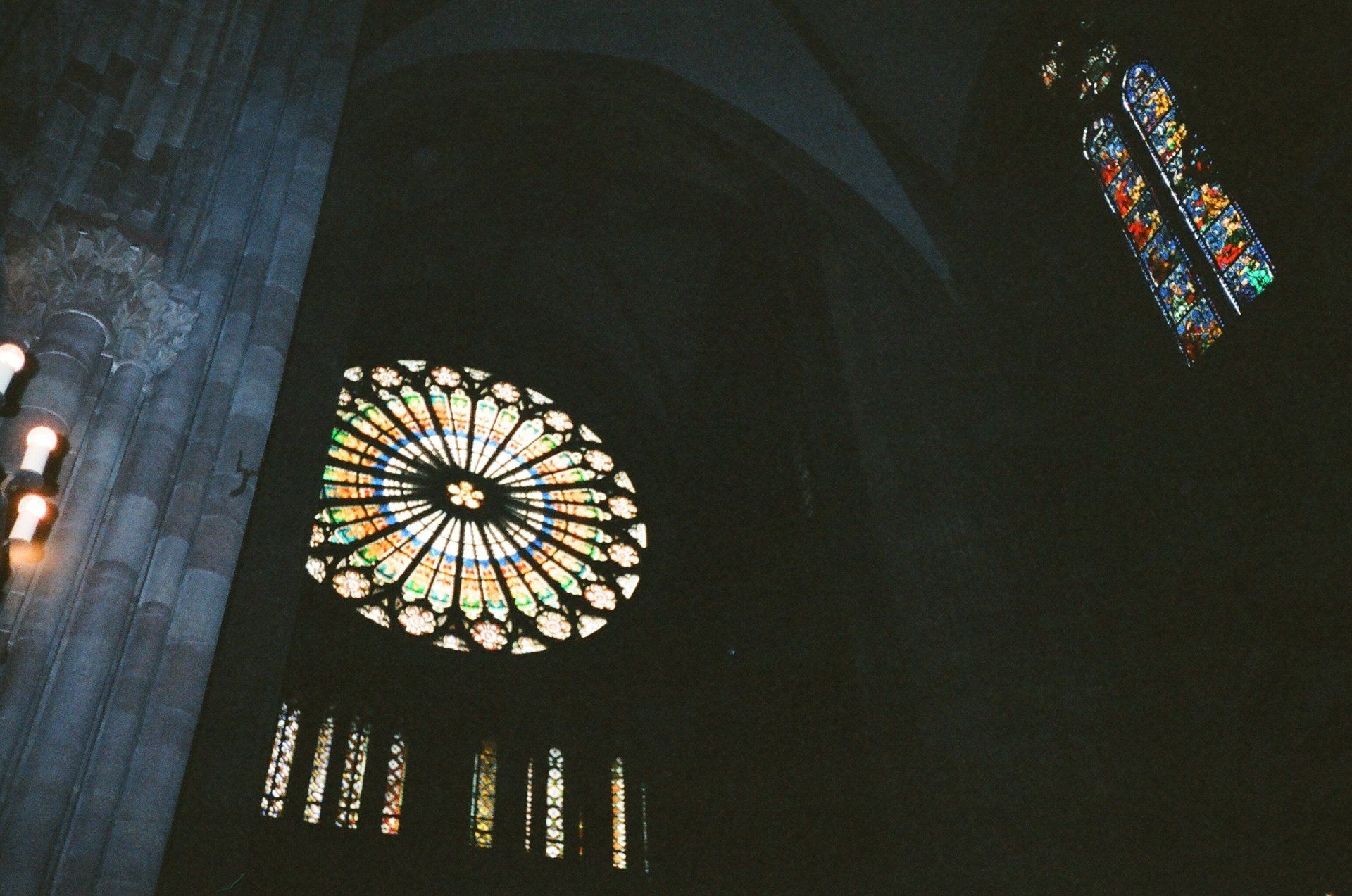 Looking up at a stained glass window in a dark room