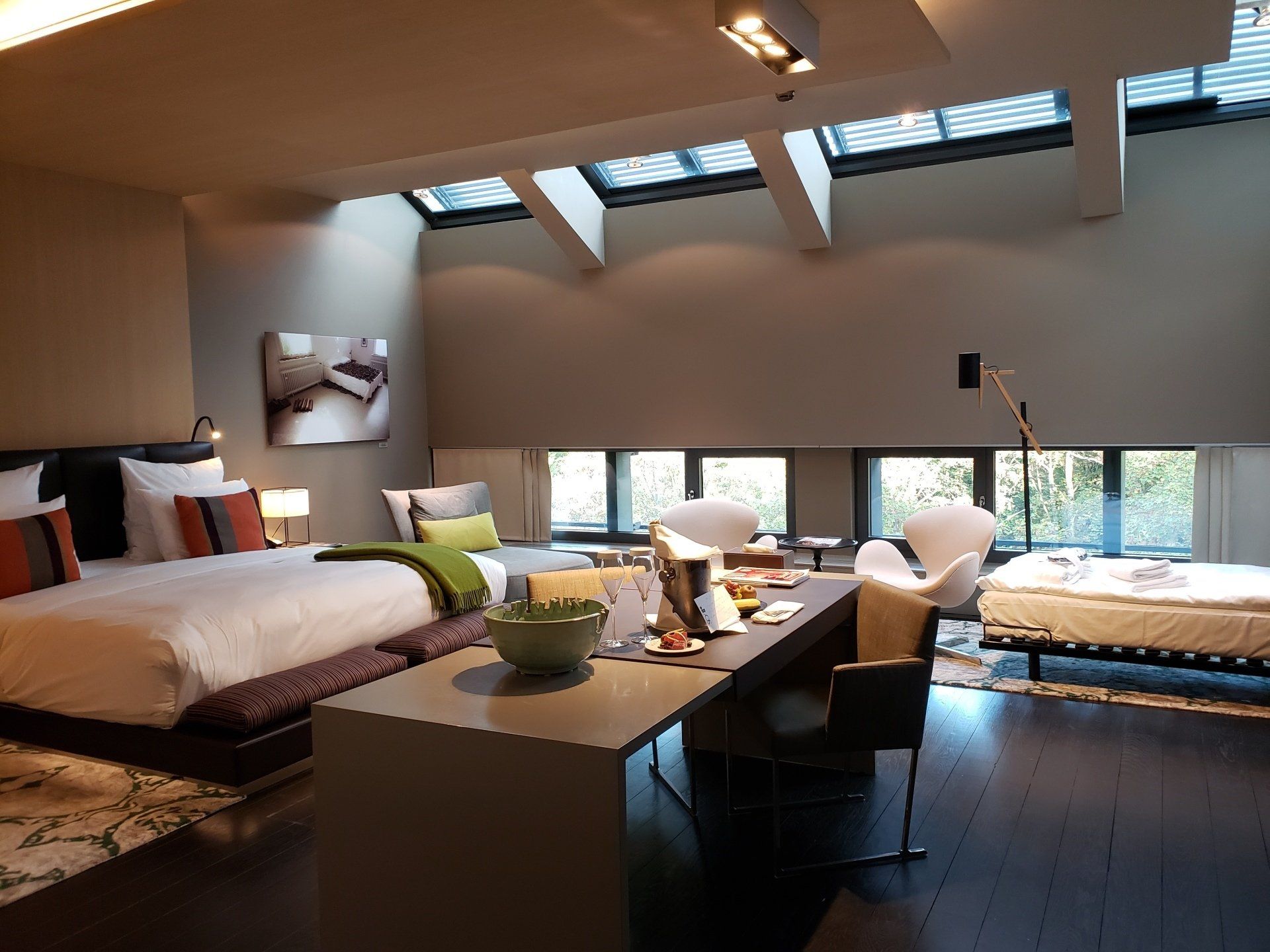 A hotel room with a king size bed and a desk