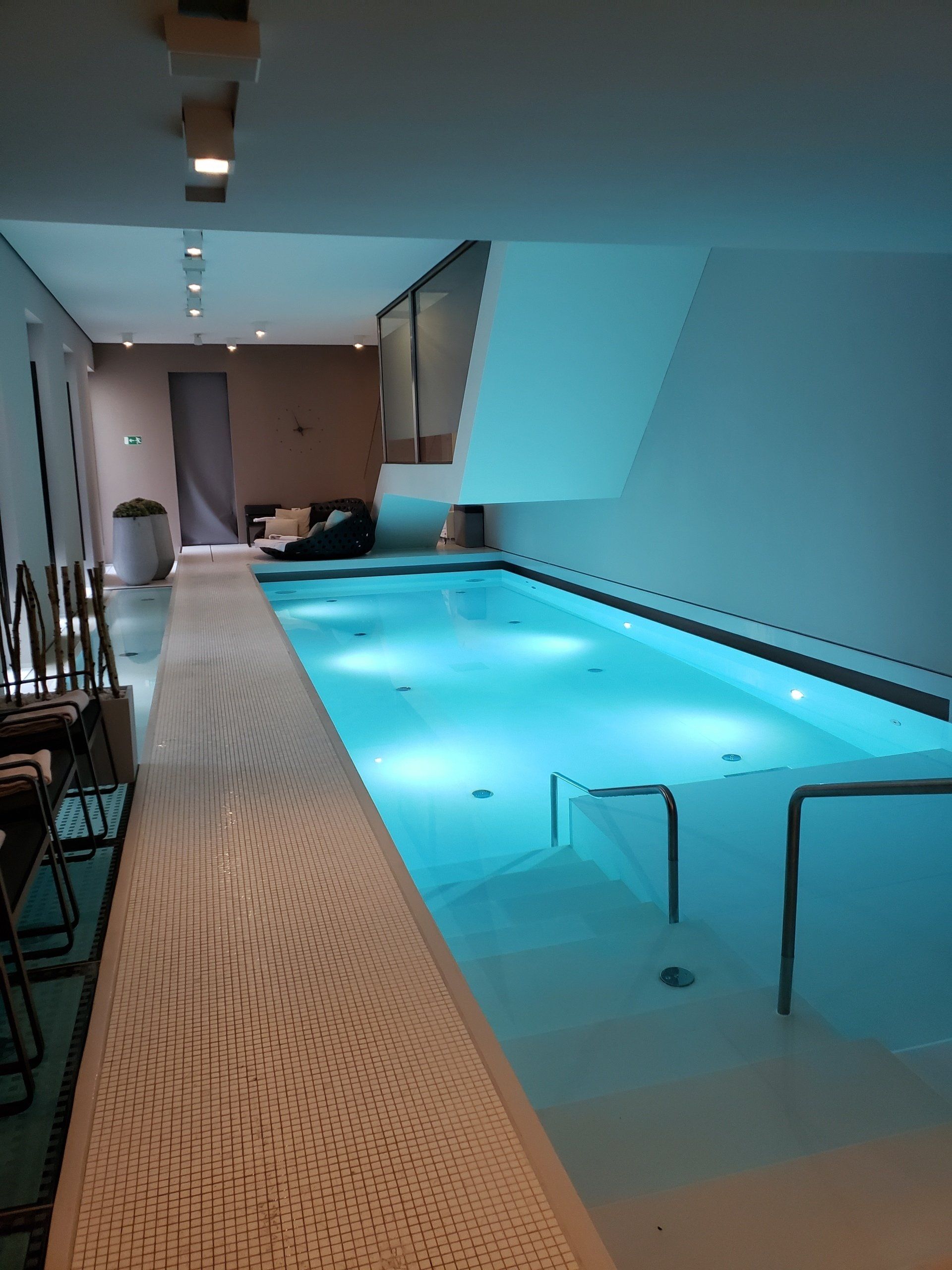 A large indoor swimming pool with stairs leading to it