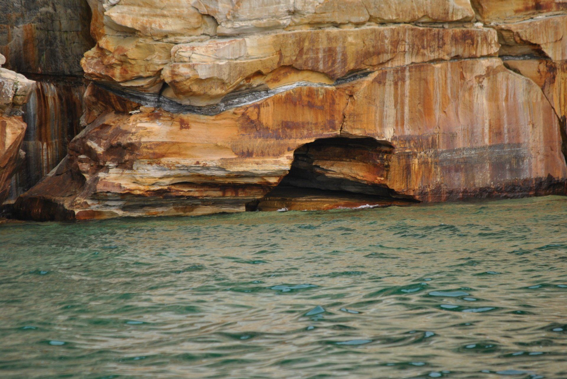 A large rock formation in the middle of a body of water.
