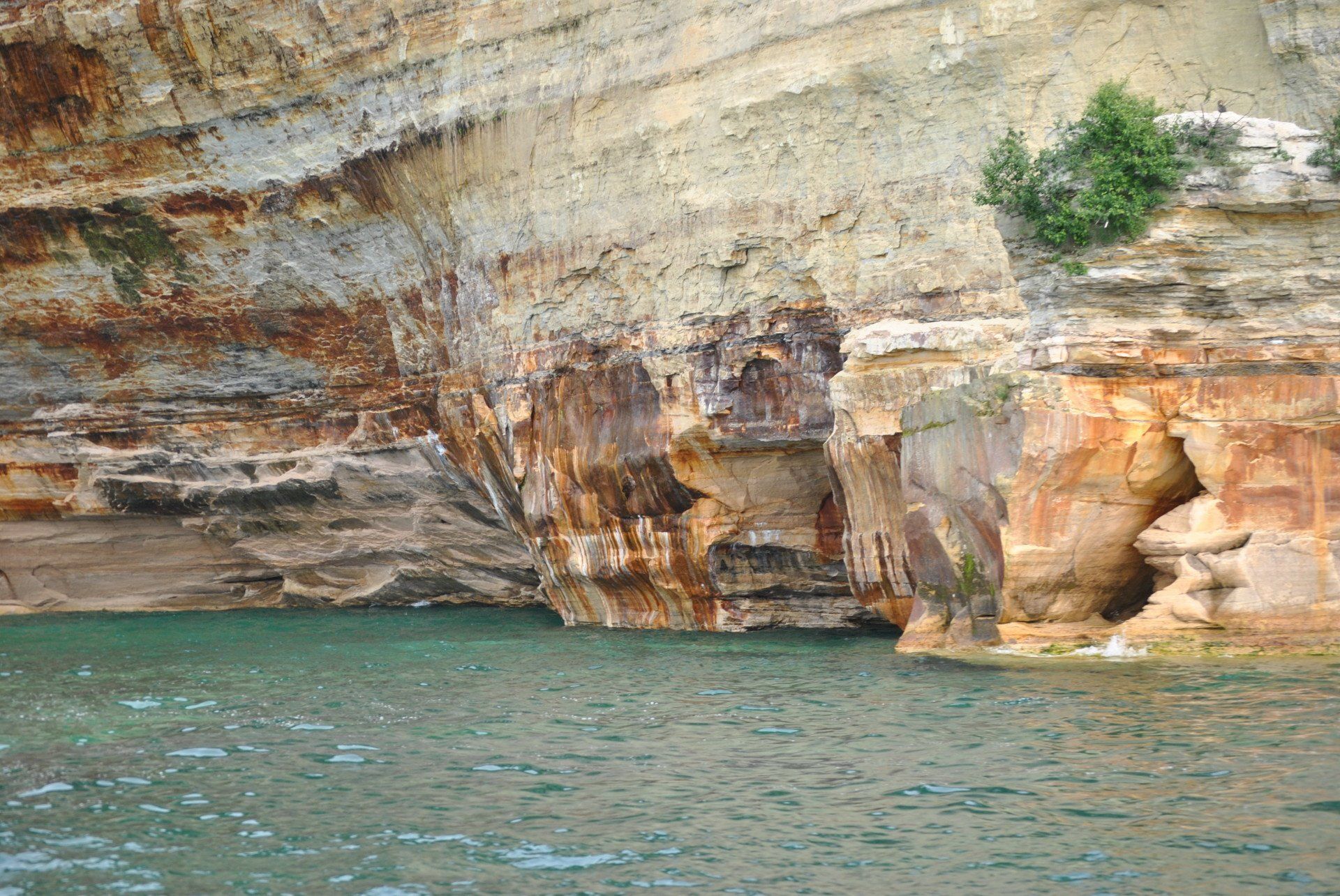 A large body of water surrounded by rocks and cliffs.