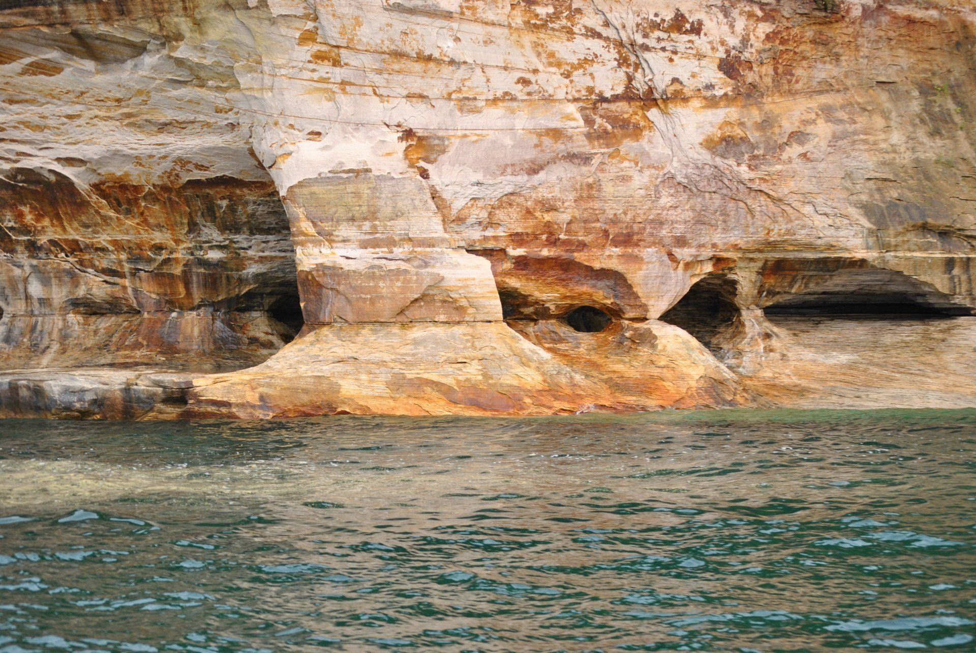 A large rock formation in the middle of a body of water.