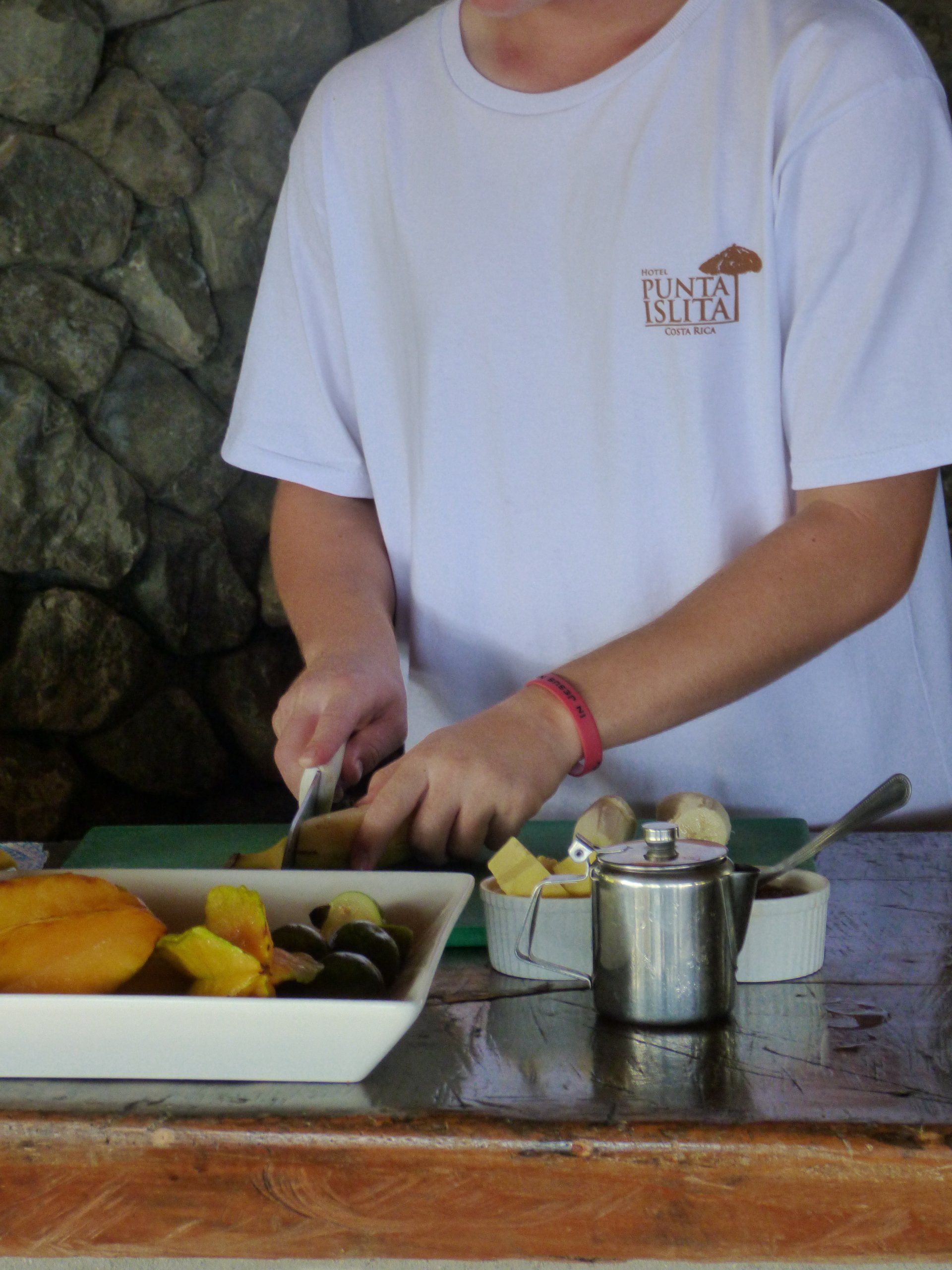 A man wearing a white shirt with the word cocoa on it
