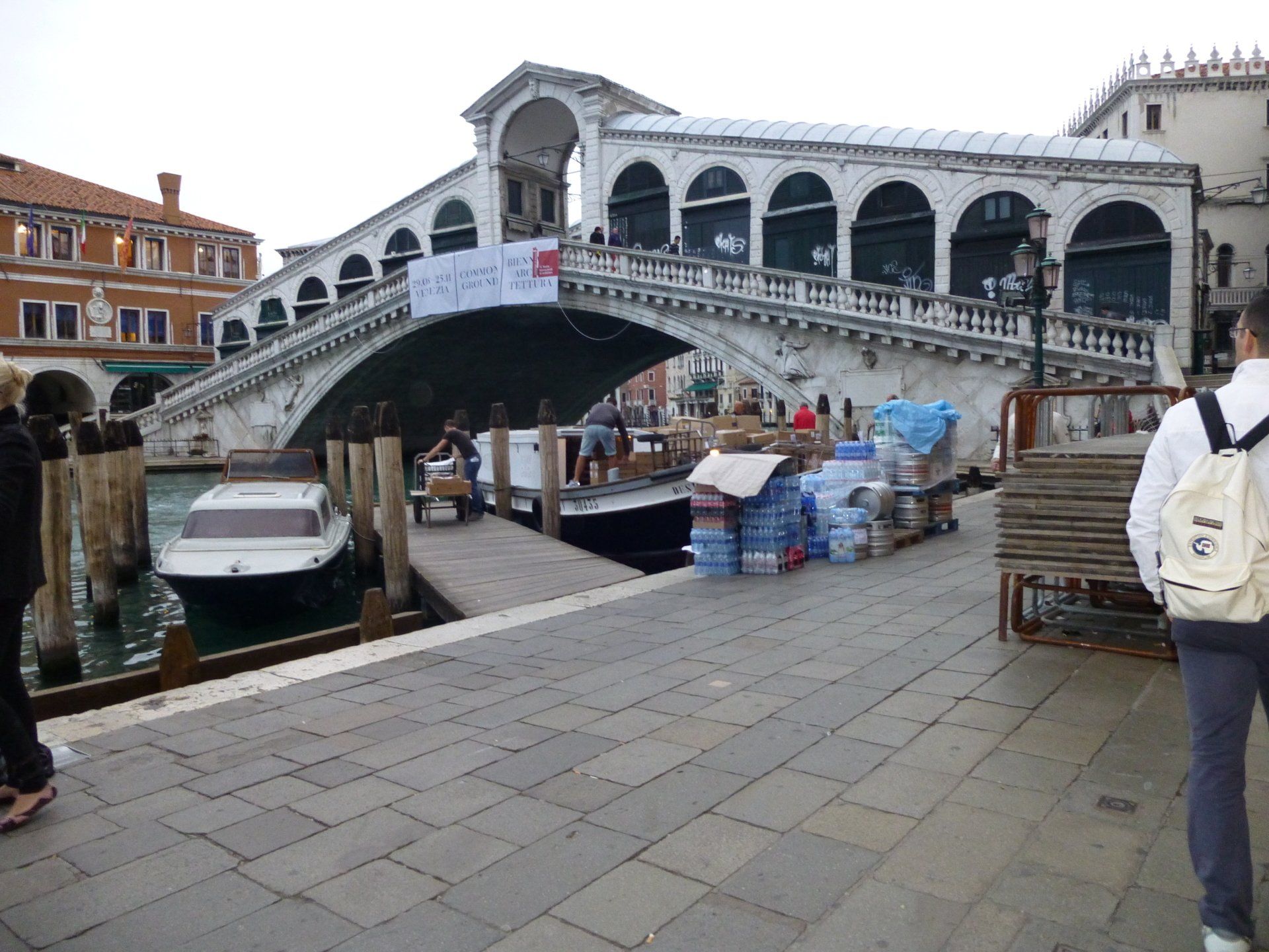 A man wearing a white backpack with the number 10 on it