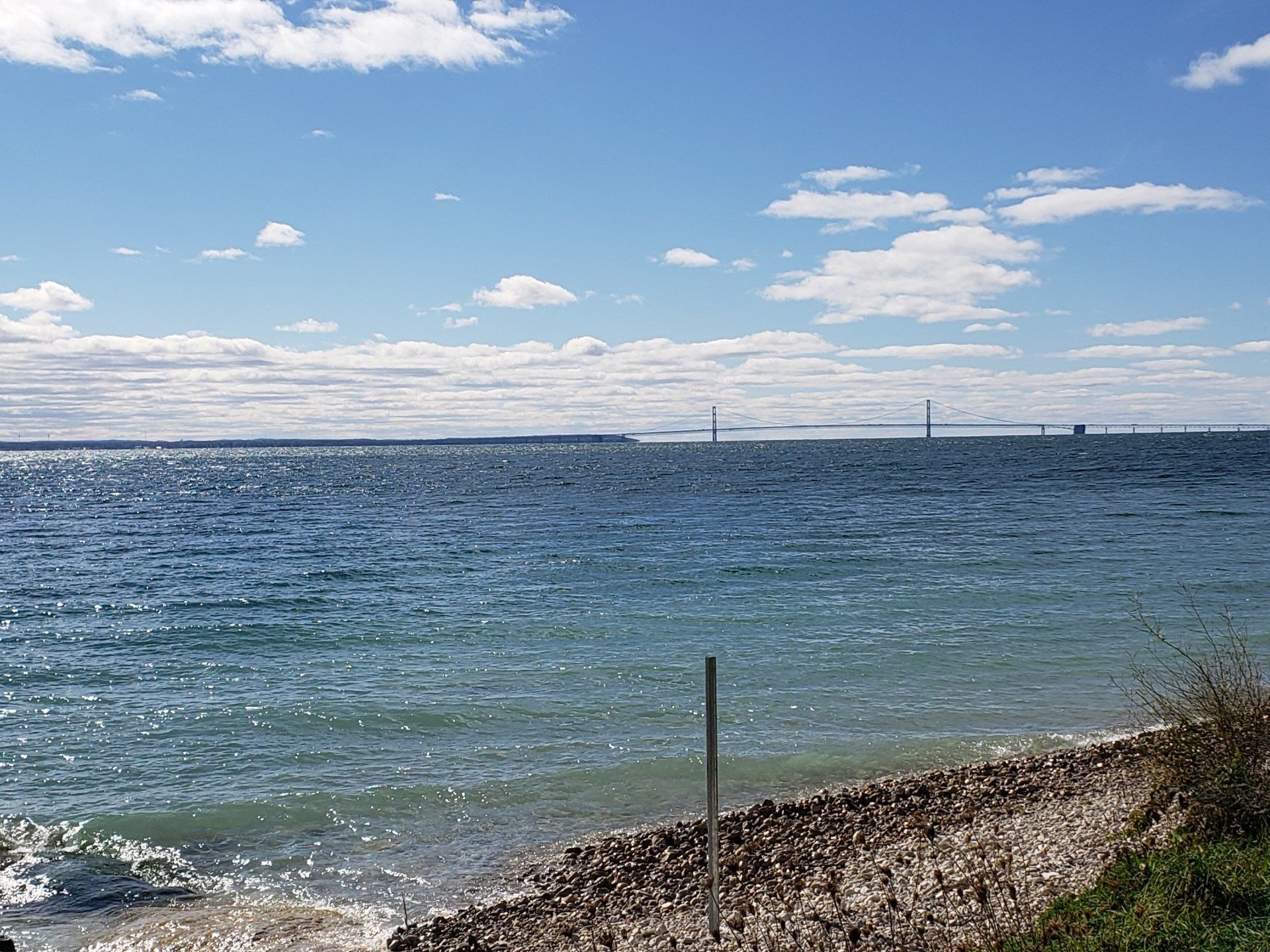 A large body of water with a bridge in the distance.