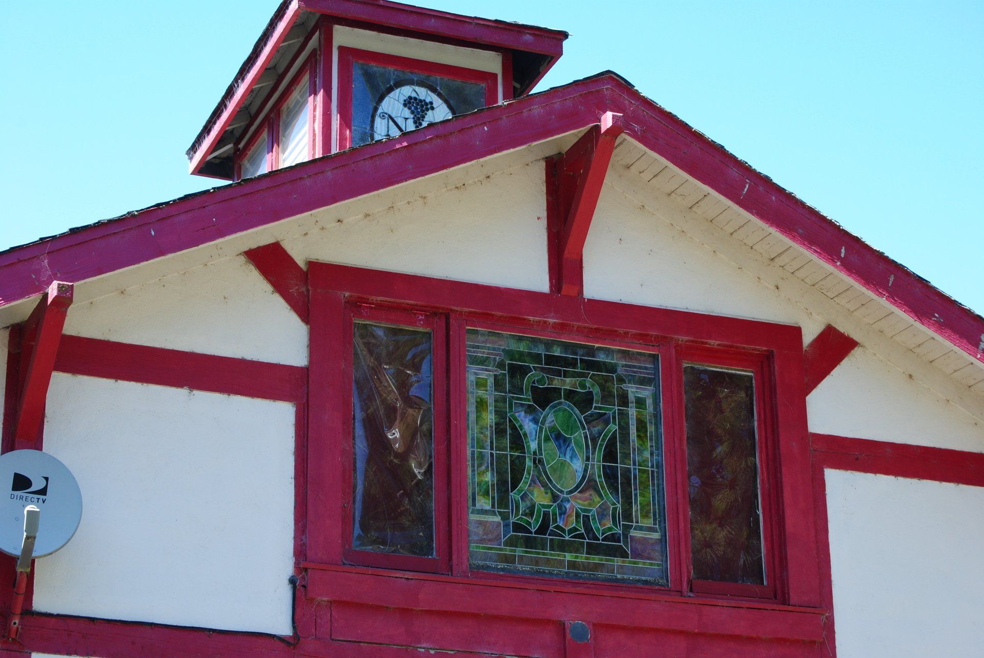 A red and white building with a stained glass window