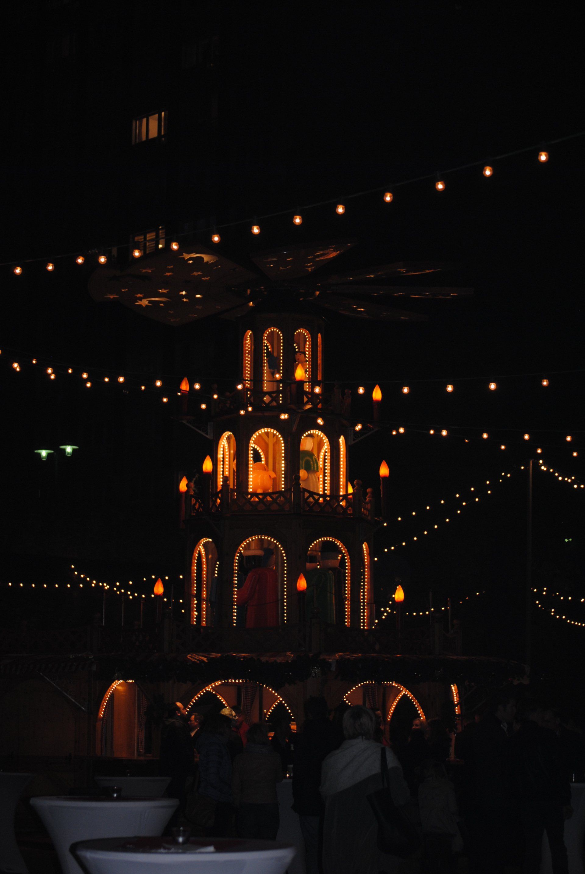 A large christmas tree is lit up in the dark