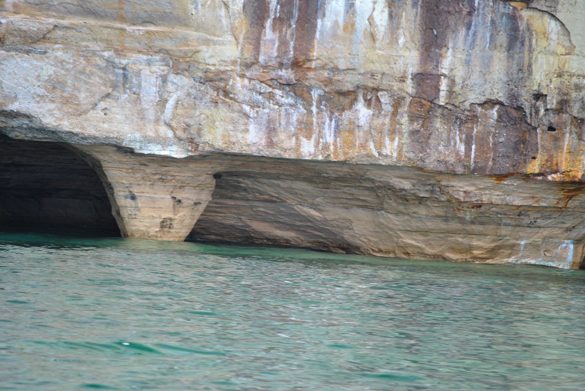 A cave in the middle of a body of water.