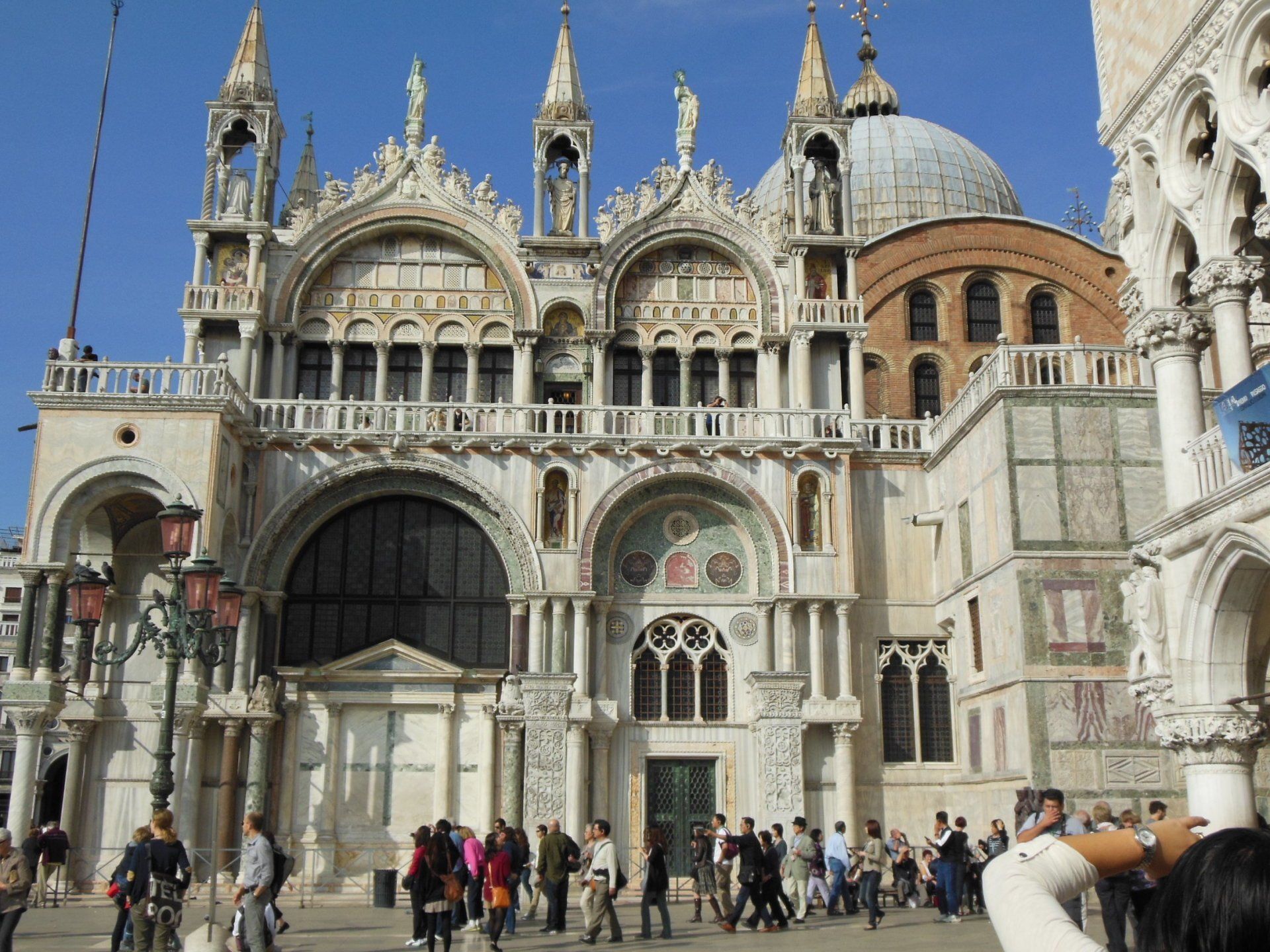 A group of people are standing in front of a large building