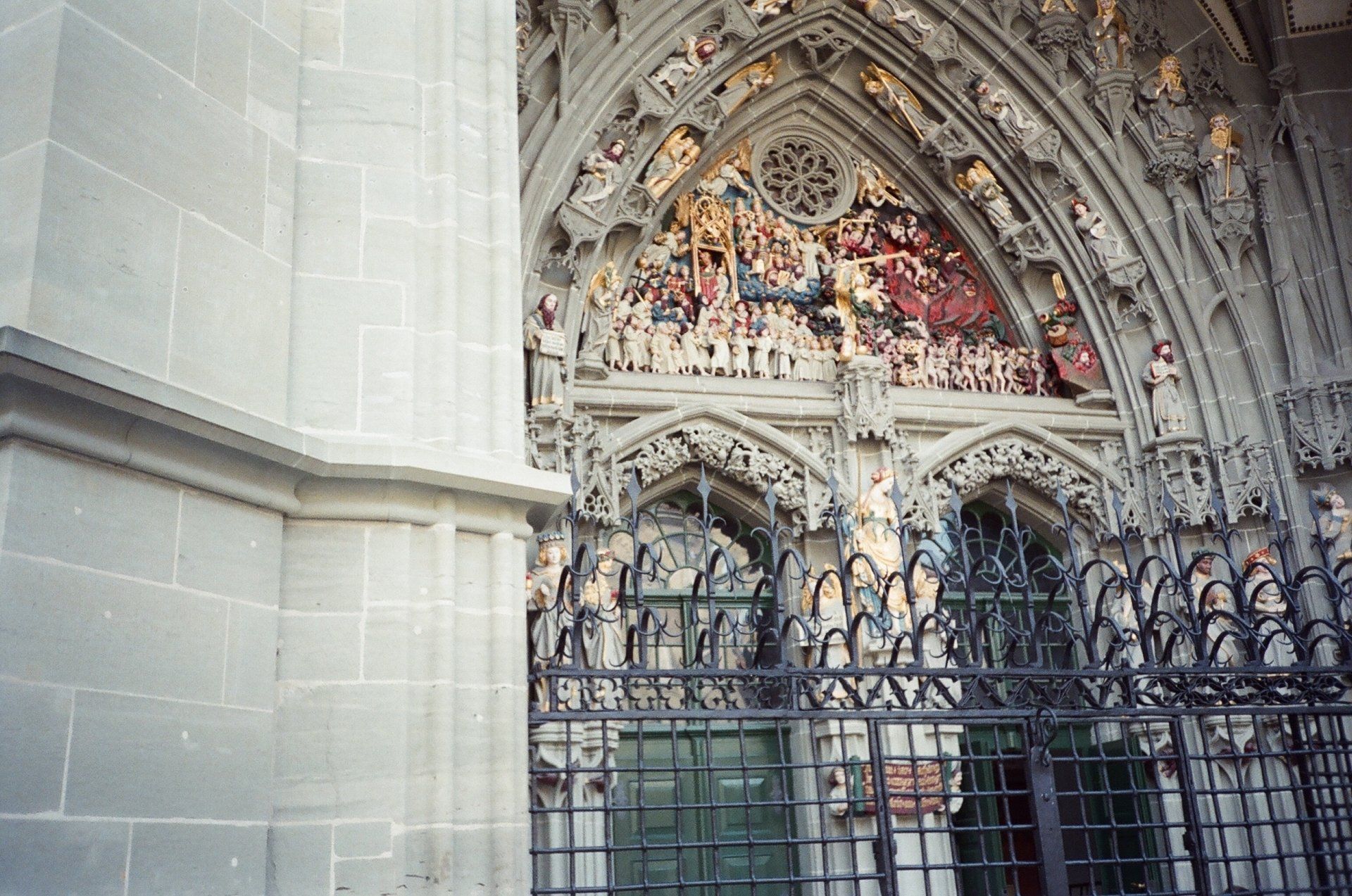 A stone building with a fence and a painting on it