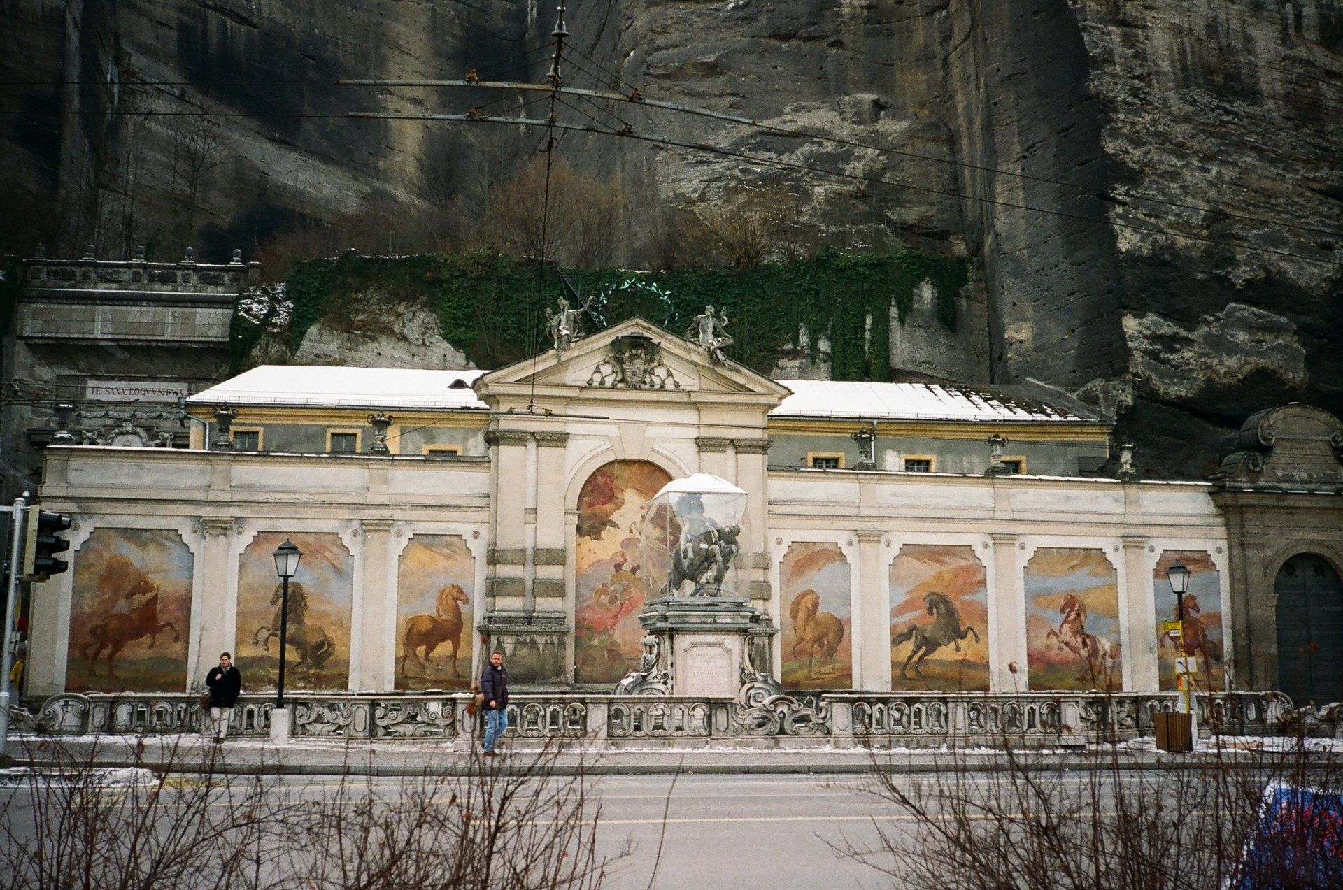 A large building with horses painted on the side of it