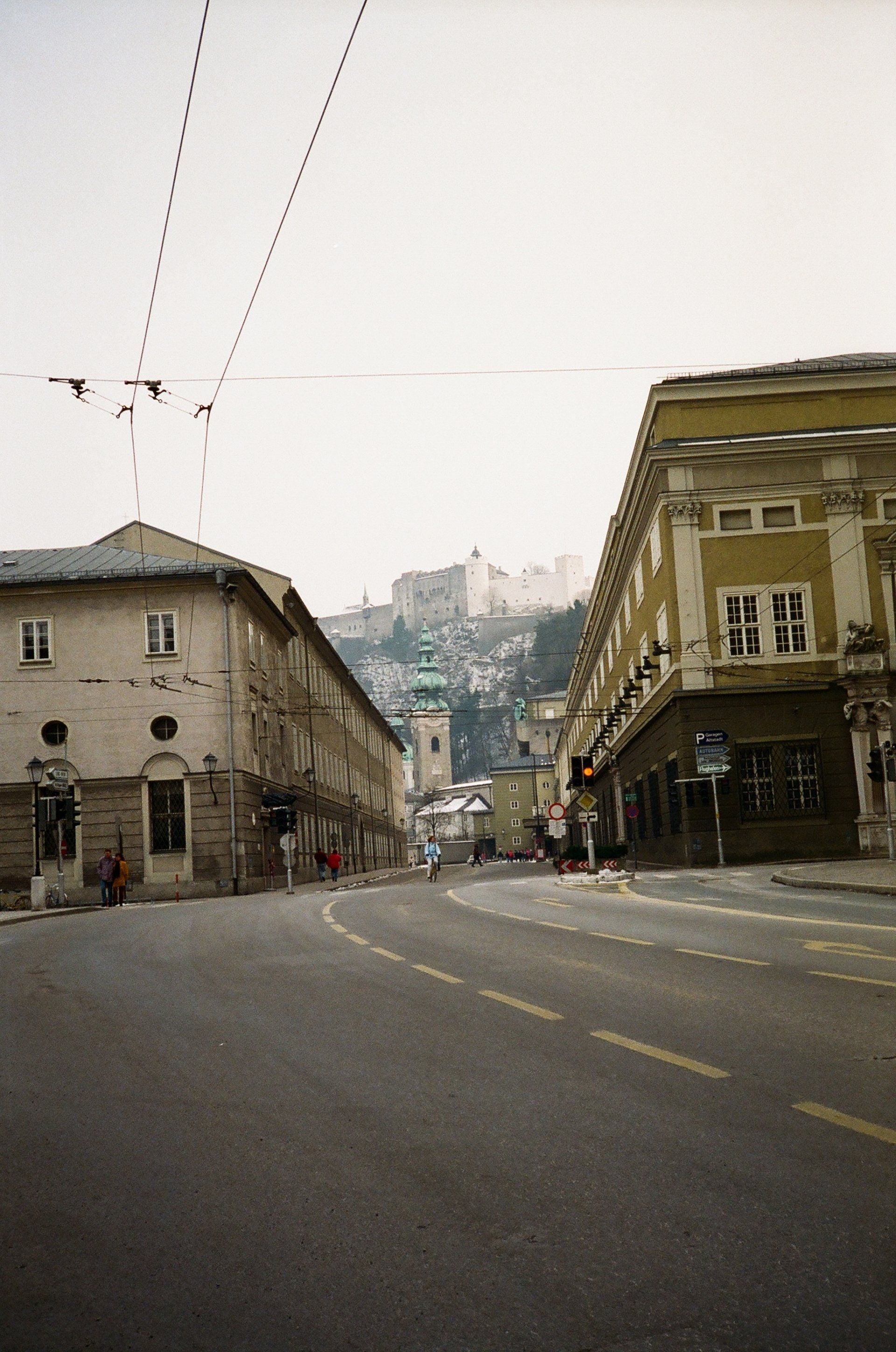 A city street with a castle in the background