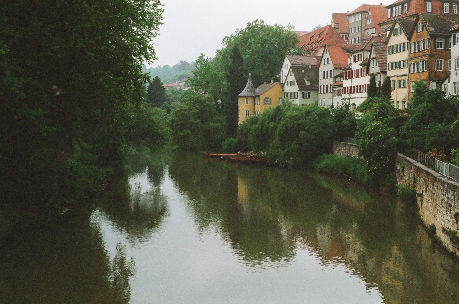 A river with a few buildings on the shore