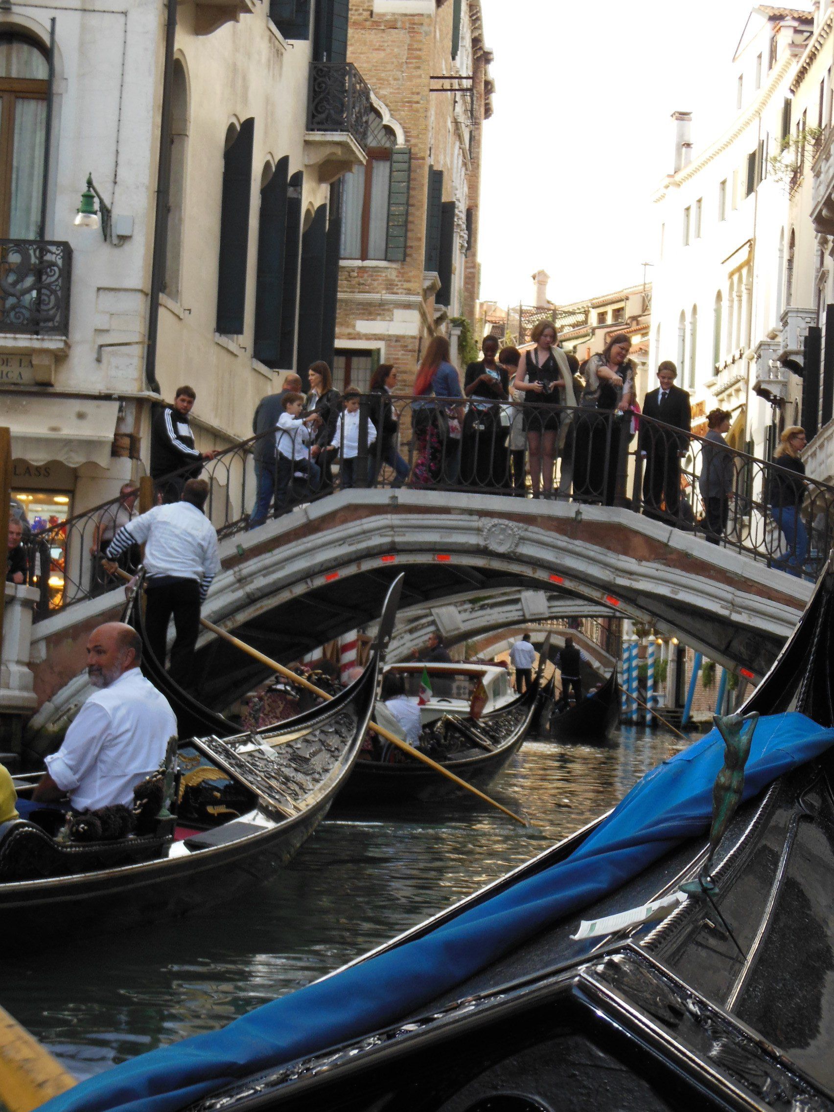 A group of people standing on a bridge over a body of water