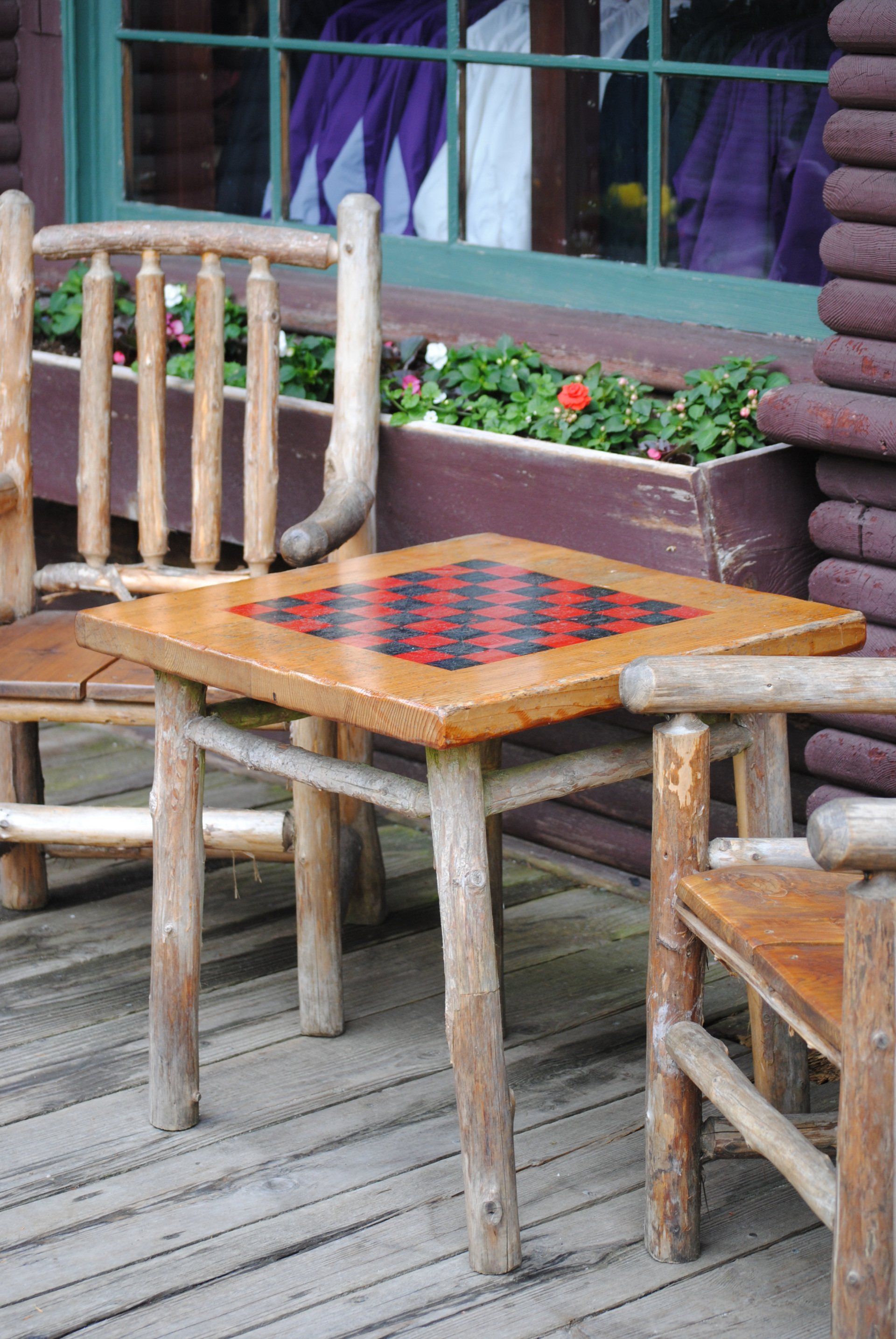 A wooden table with a chess board on it
