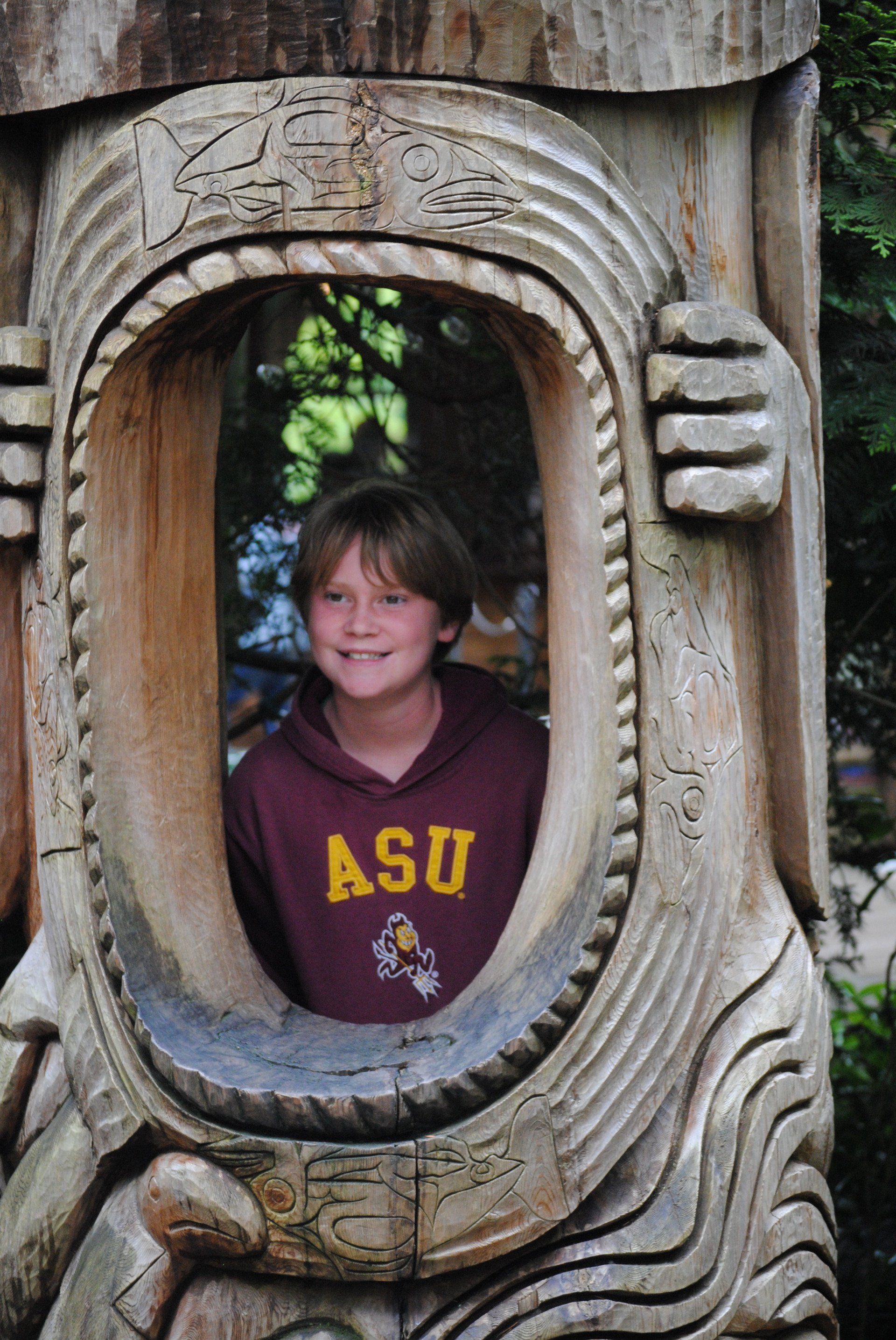 A young boy wearing a sweatshirt with asu on it