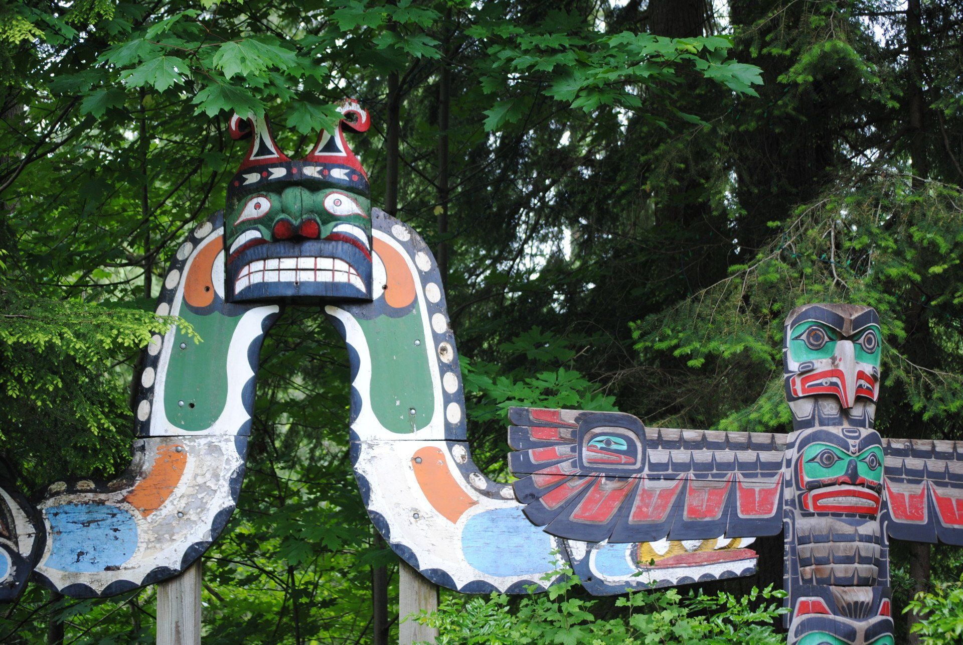 A totem pole with a dragon on top of it