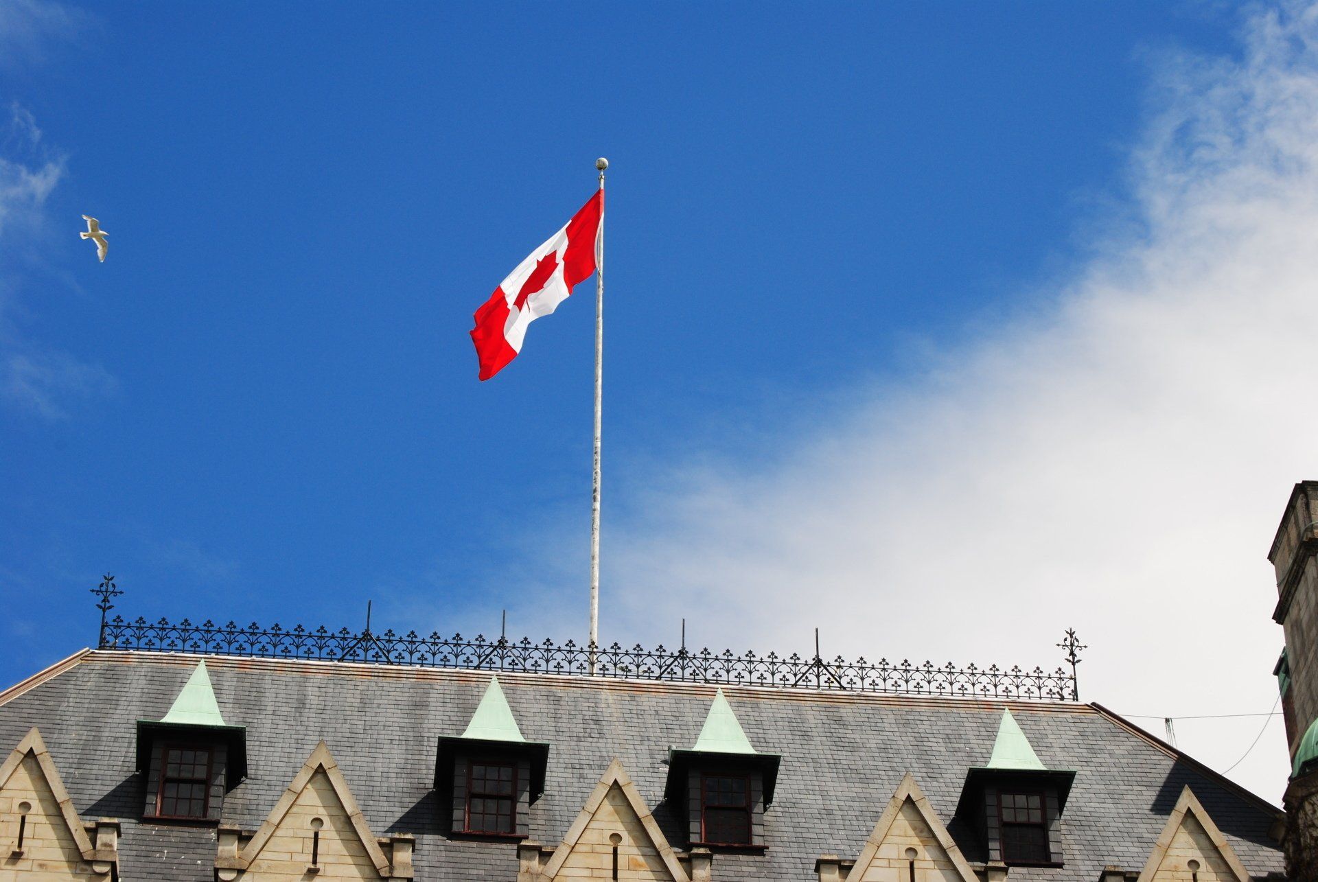 A canadian flag is flying on top of a building
