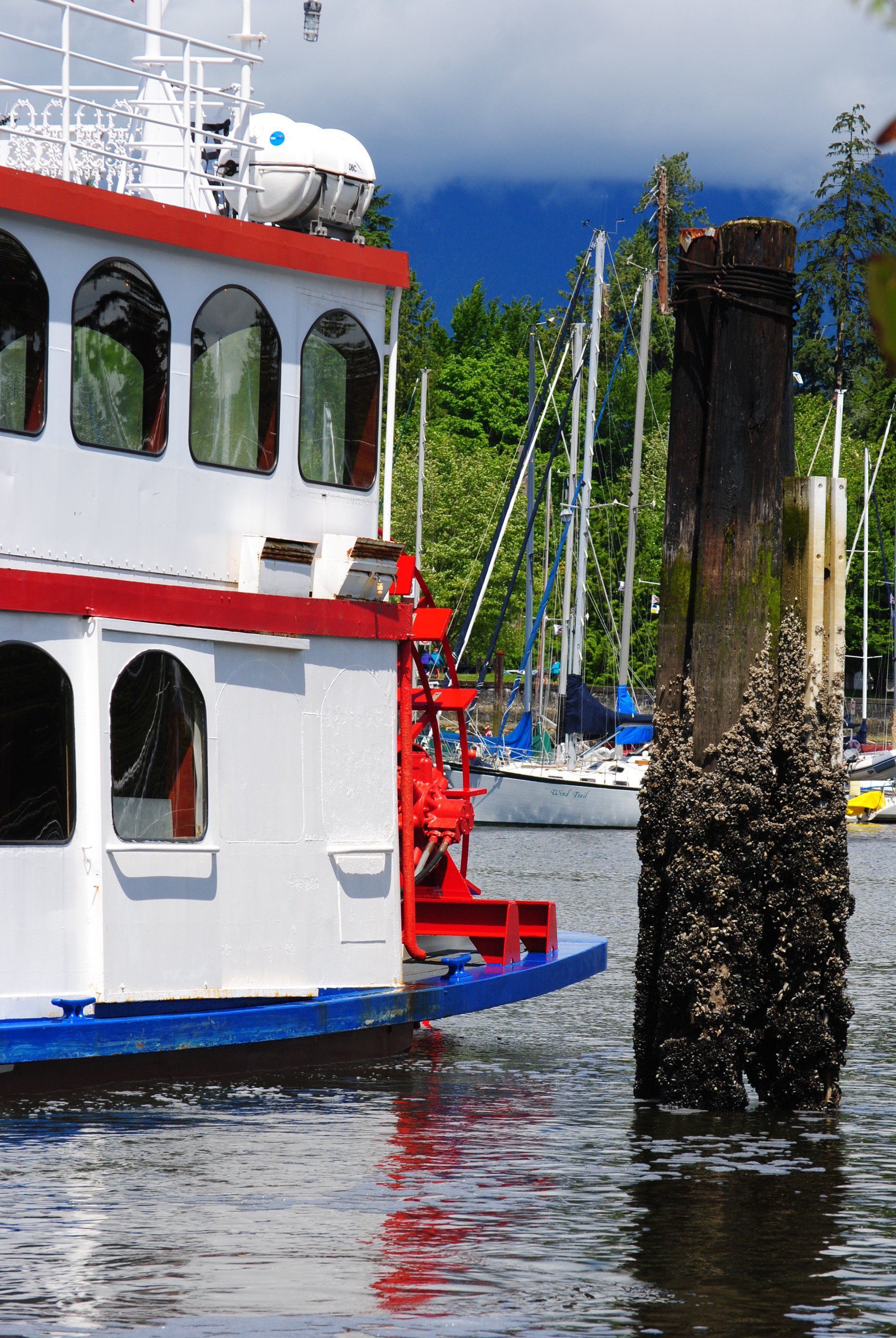 A boat is docked next to a wooden post in the water