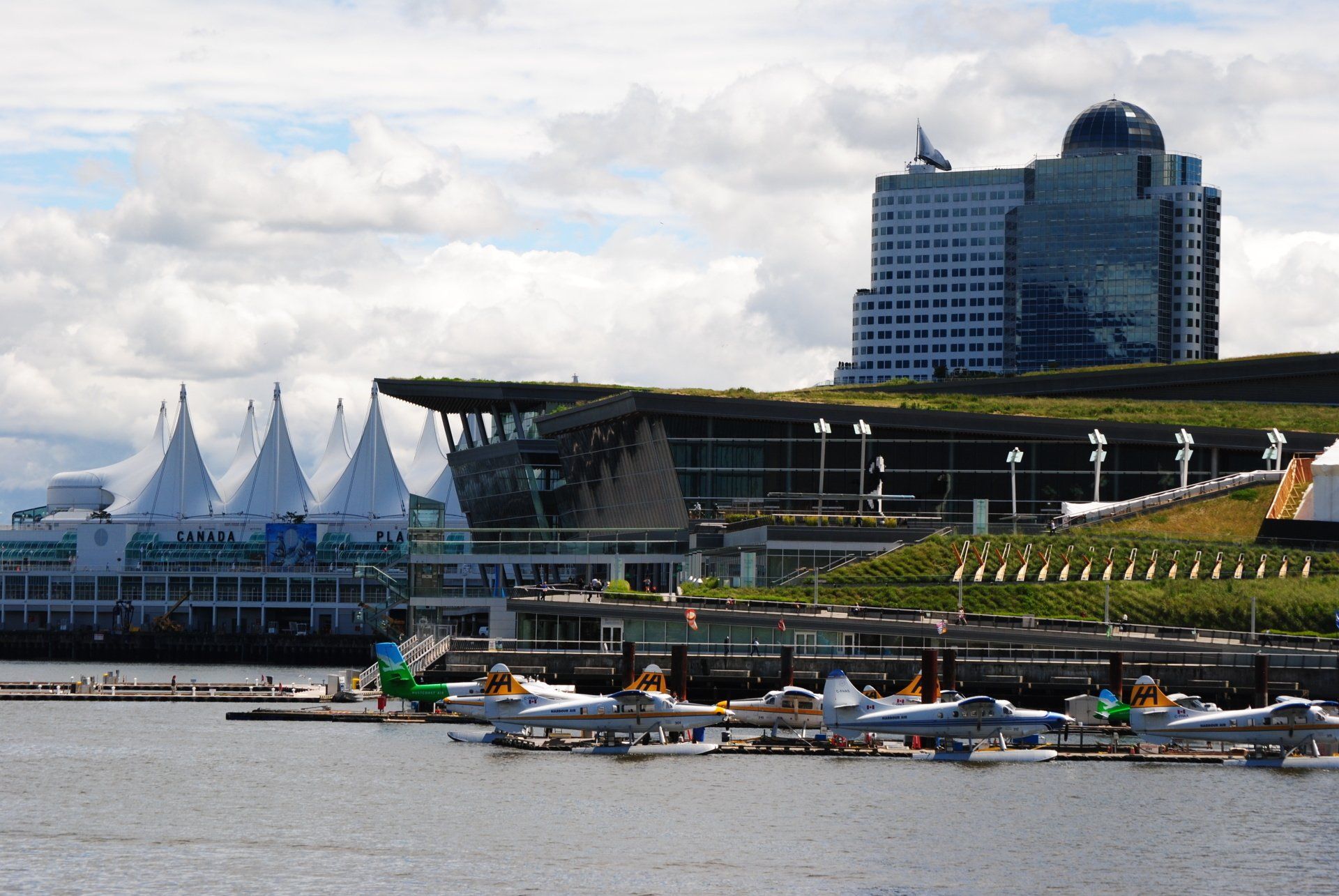 Several boats are docked in front of a large building