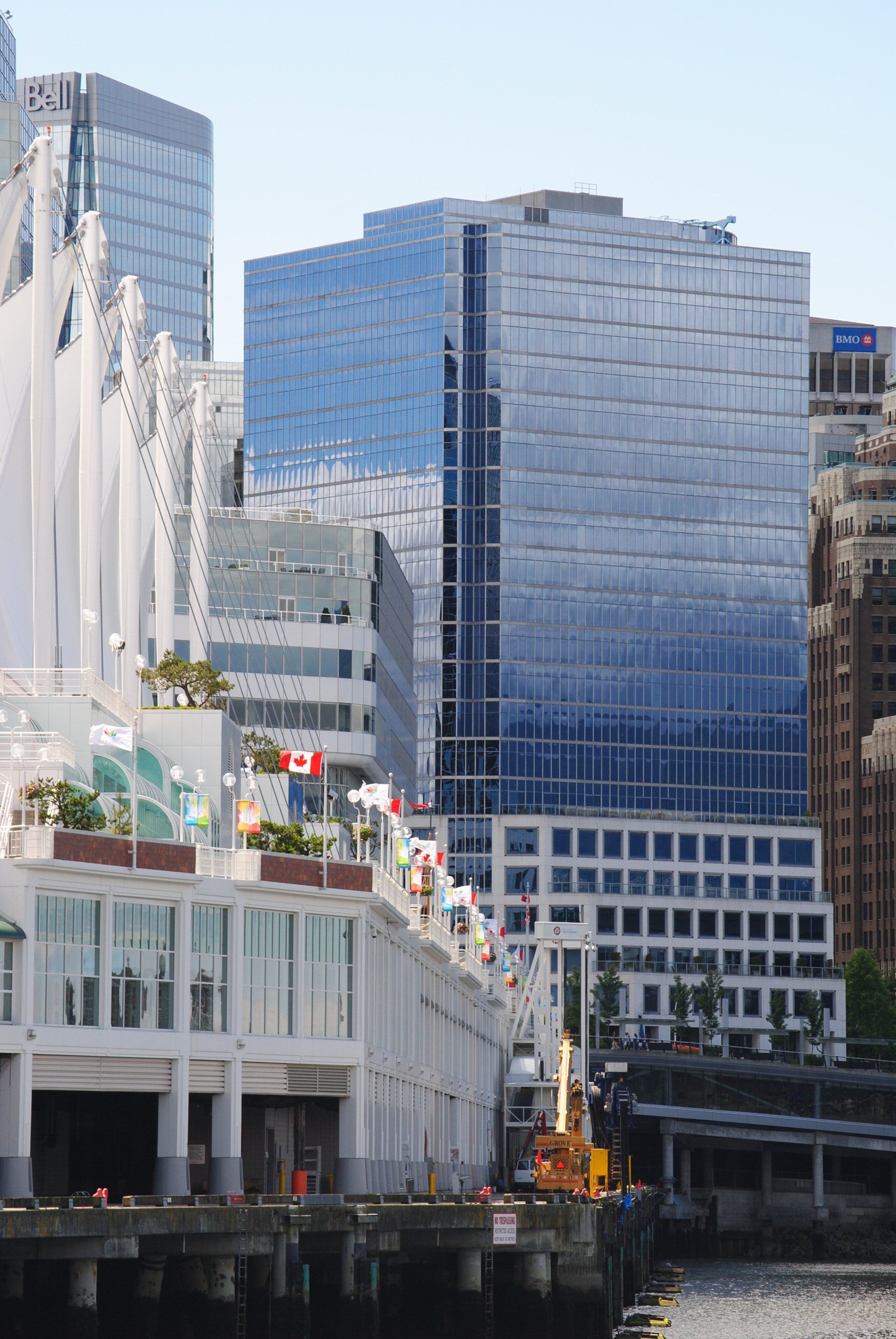 A city with a lot of tall buildings and a river in the foreground
