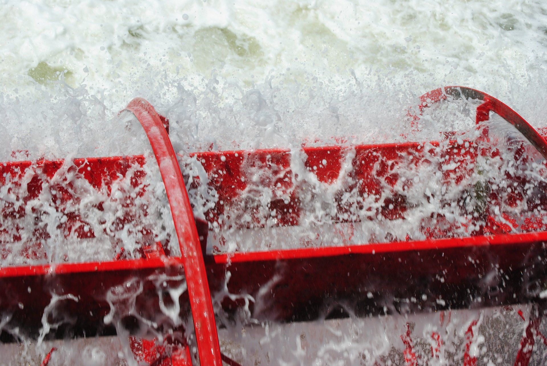 A close up of a red object with water coming out of it